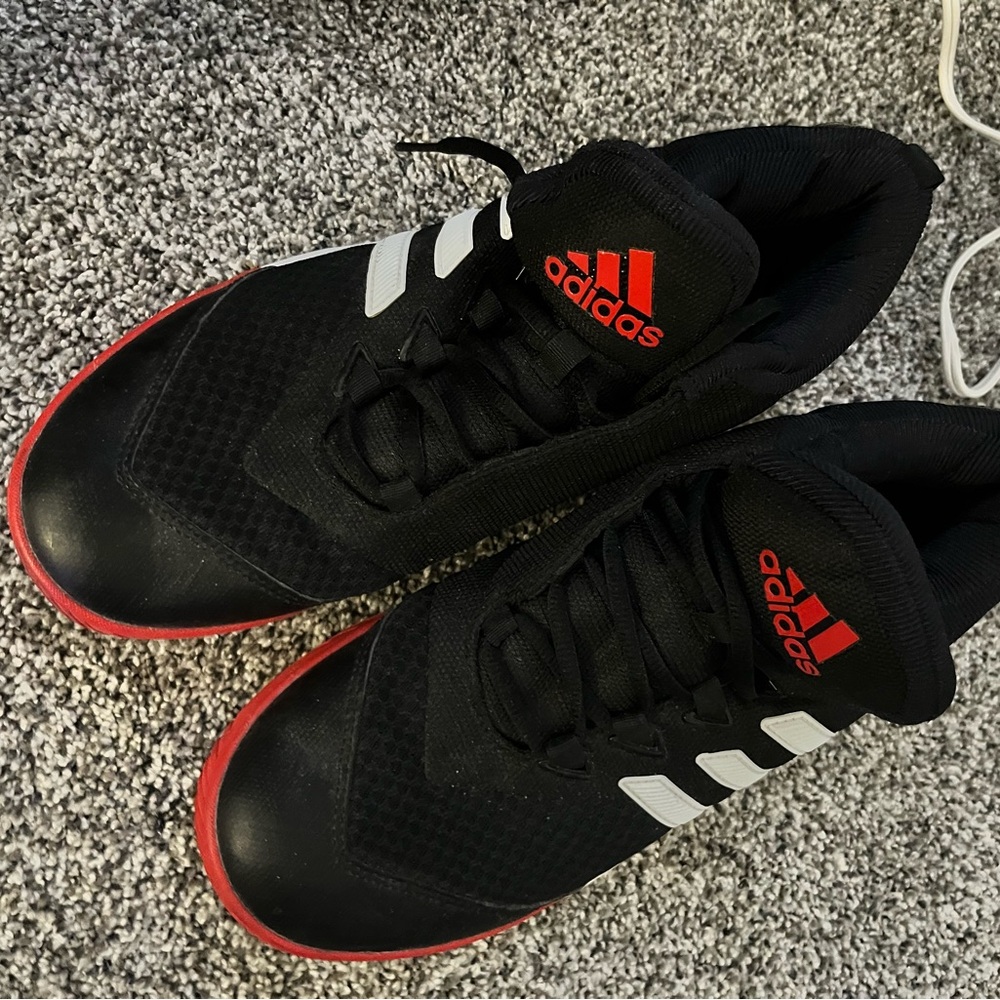 Adidas Black w/ red stripes and red soles. Mens Size10.Barely worn.Sporty style